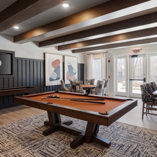 State-of-the-art amenities a clubroom with a pool table and a tv